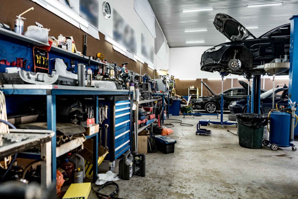 garage upgrade ideas, visual of a garage storage space with cars in the background
