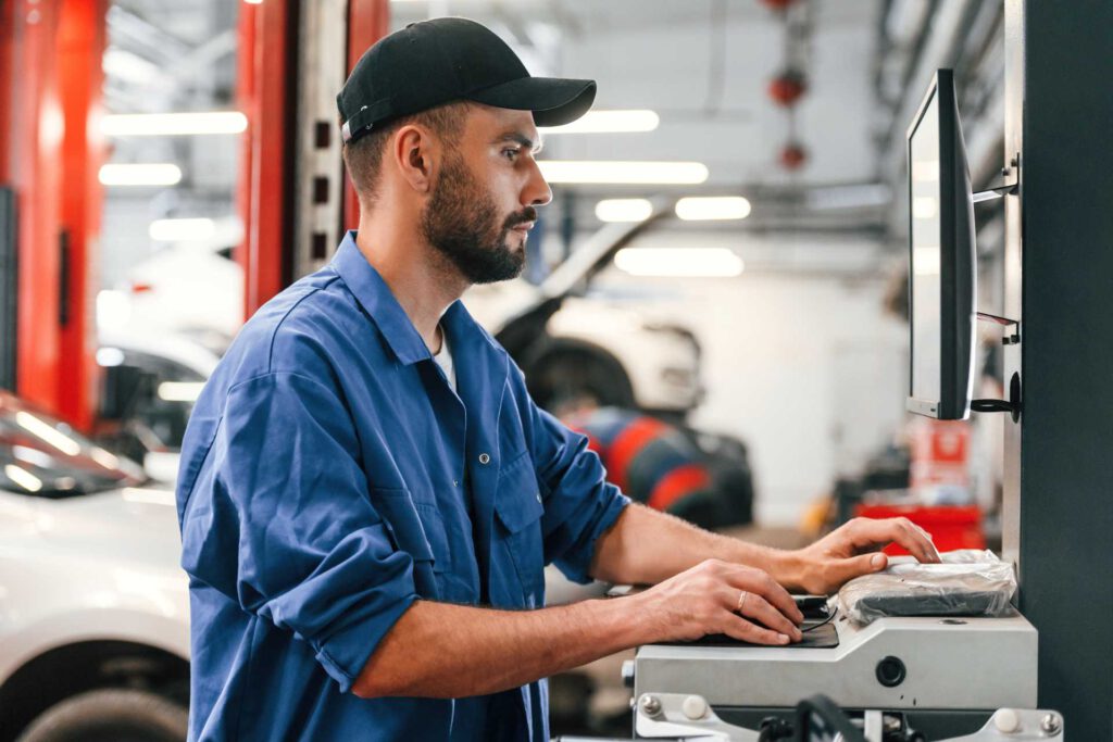 complete garage management system, mechanic logging in data on computer