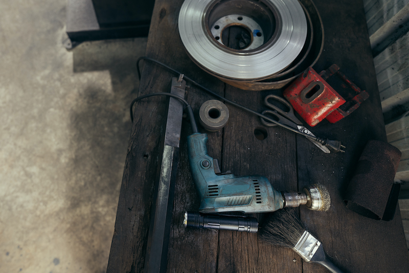 New garage tools, older car garage tools on a table.