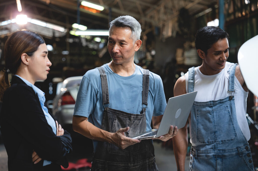 Mechanics inspecting a car for repair