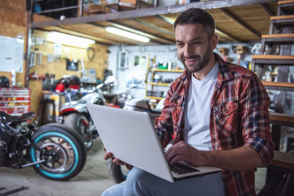 garage base cost, mechanic using computer in garage